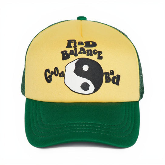 Yellow and green cap with a yin yang symbol and text on a white background
