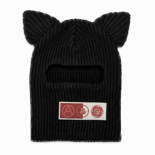 Black knit beanie with cat ears on a white background