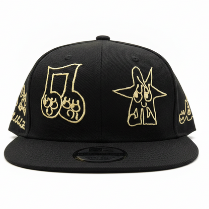 Black cap with gold embroidered designs on a white background
